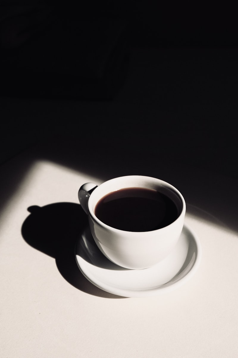 Glass pour over coffee maker with filter, brewing fresh coffee on a dark counter